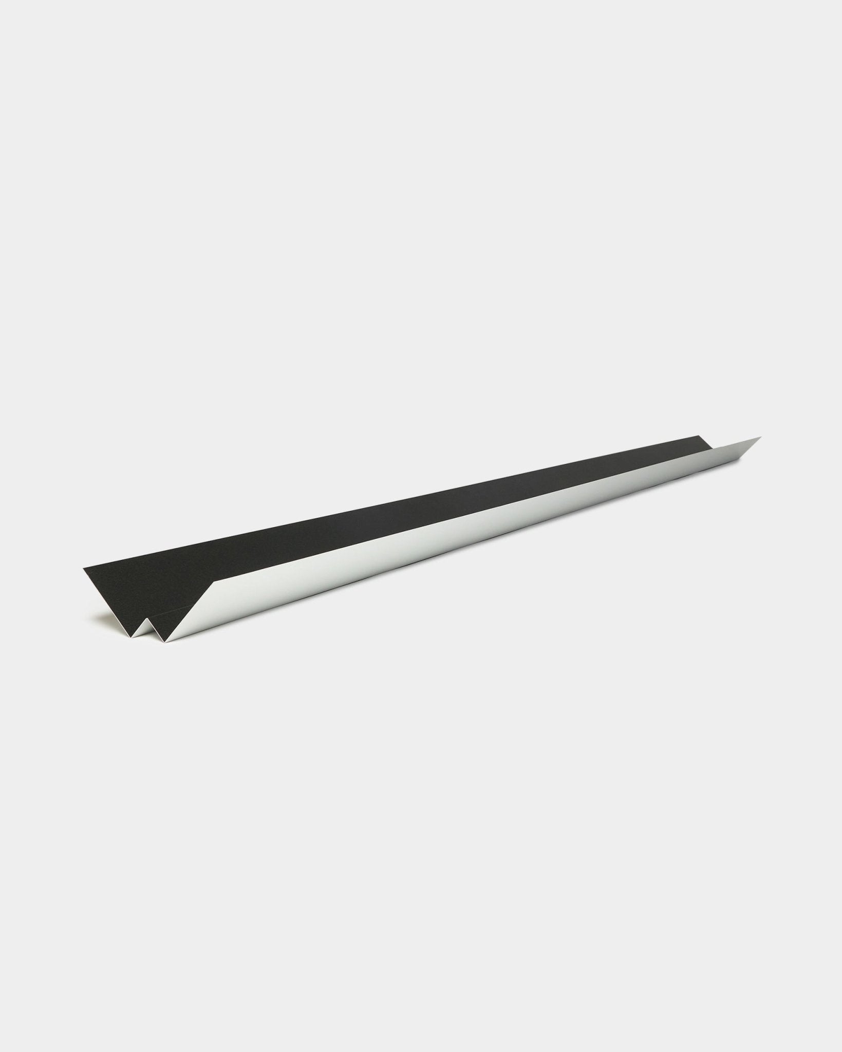 Minimalist black and white paper airplane design referencing the sleek lines and geometric profile of WoodUpp’s Aluwood facade panel Inside Corner, 240 cm.
